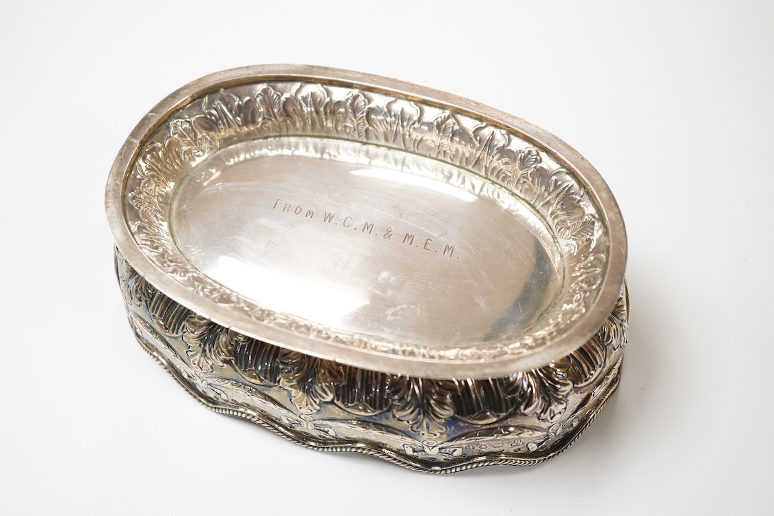 A late Victorian embossed silver oval bowl, by Charles Stuart Harris, with engraved initials to the base, London, 1890, length 16.4cm, 7.3oz.